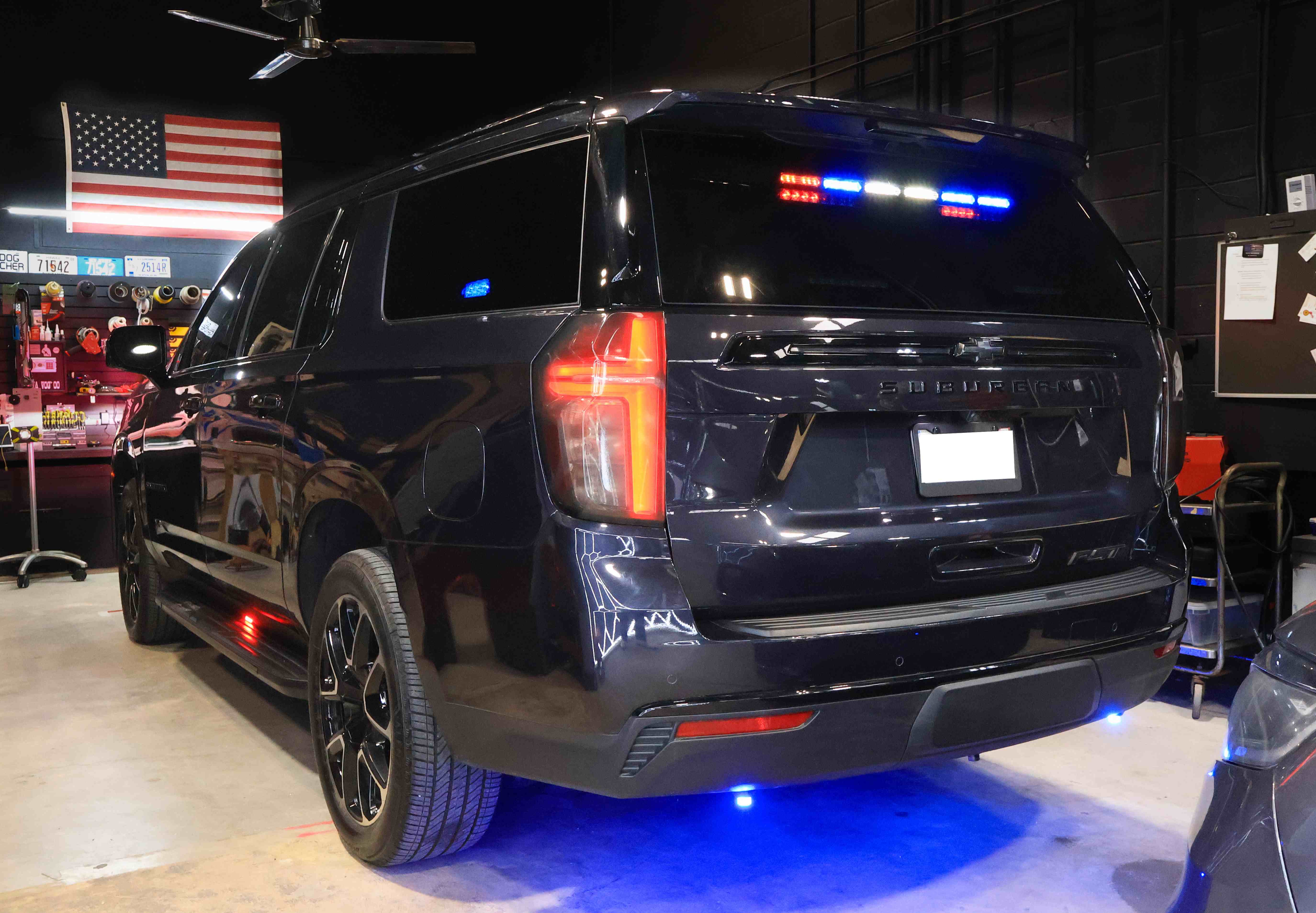 Police SUV with emergency lighting in workshop